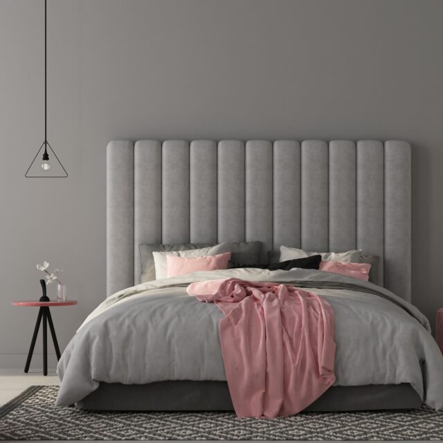 Interior of the bedroom where there are a large gray bed with a large soft headboard, stylish soft poufs and a table in pink colors / 3D illustration3d render