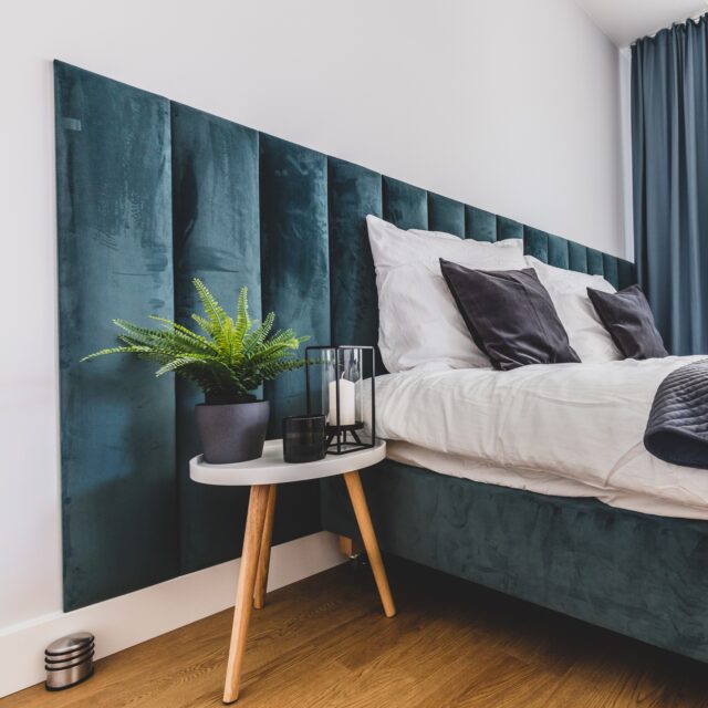 Cozy bedroom with comfortable bed in modern studio apartment. Interior design